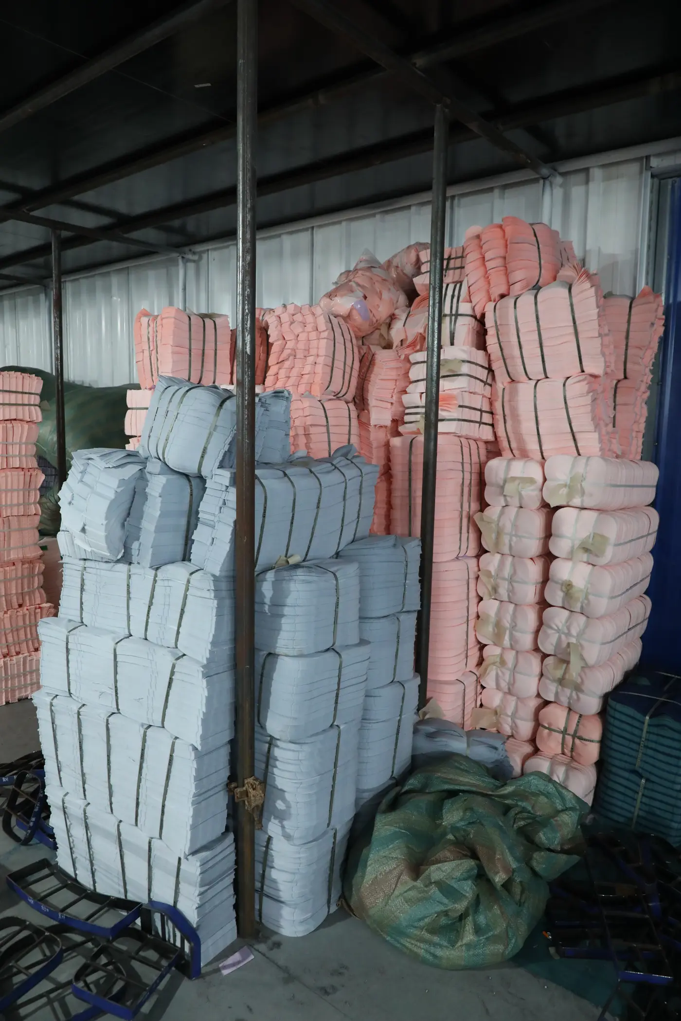 Bundled and ticketed cut backpack panels racked by colour