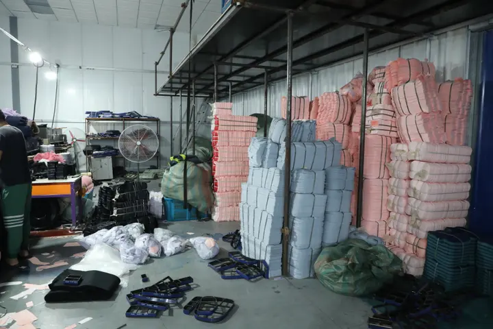 Bundled and ticketed cut backpack panels racked for the sewing lines