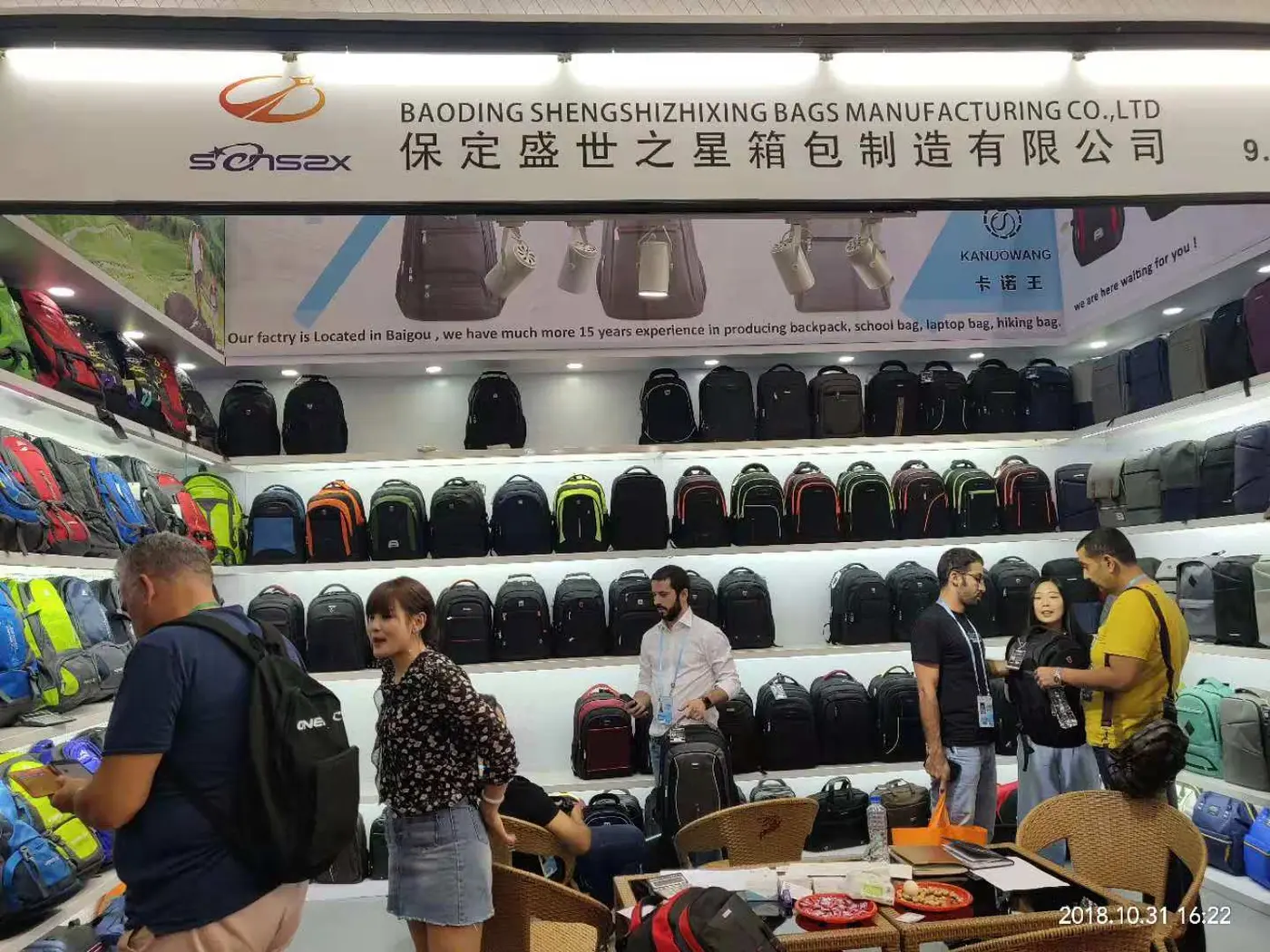 Buyers reviewing school backpacks at the Senszx booth, Canton Fair