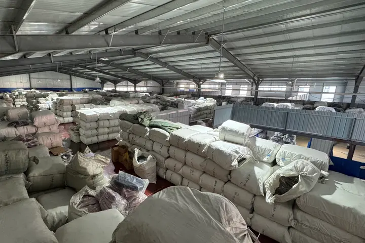 Compressed bales of wholesale backpacks stacked for container loading