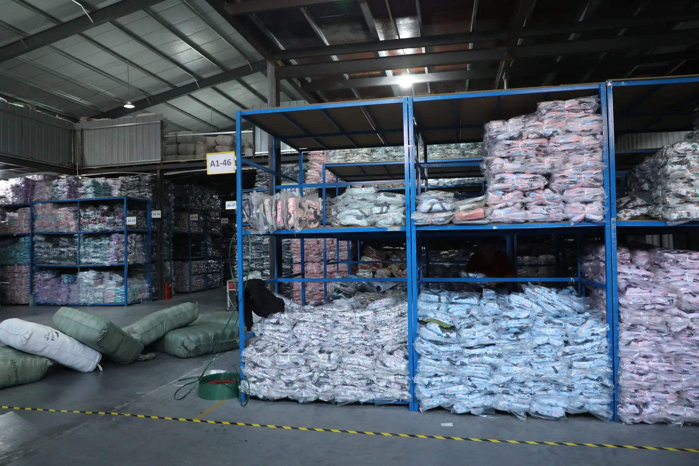 Finished school backpacks poly-bagged and racked in the Senszx warehouse before cartoning